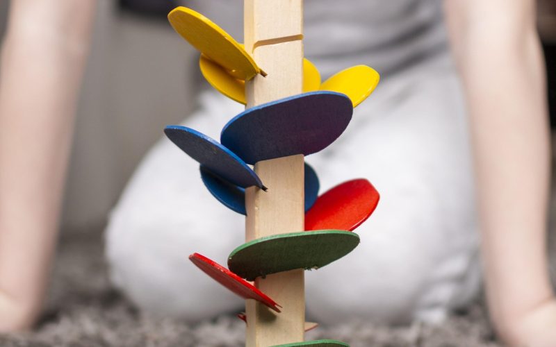 child-playing-with-colorful-wooden-game